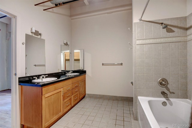 bathroom featuring tile patterned floors, double vanity, a sink, and bathtub / shower combination