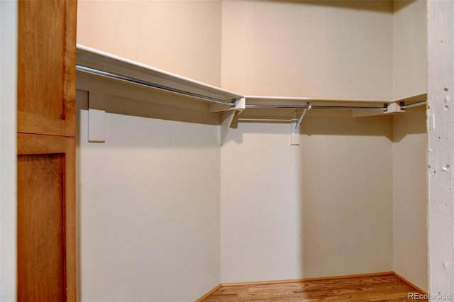 spacious closet with wood finished floors