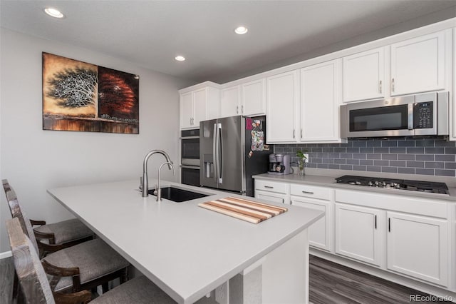 kitchen with white cabinetry, sink, dark wood-type flooring, and appliances with stainless steel finishes