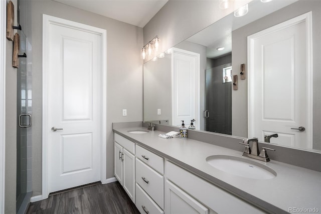 bathroom with vanity, wood-type flooring, and walk in shower