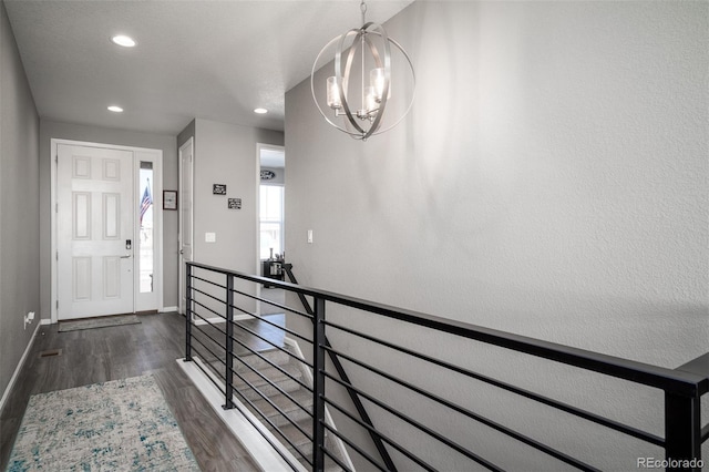 interior space featuring dark wood-type flooring and a notable chandelier