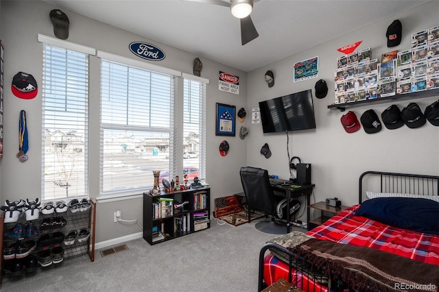 bedroom featuring carpet flooring, ceiling fan, and multiple windows