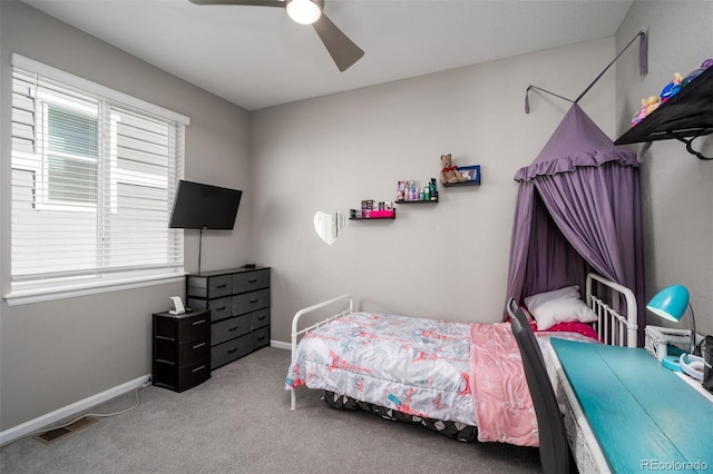 bedroom featuring multiple windows, light colored carpet, and ceiling fan