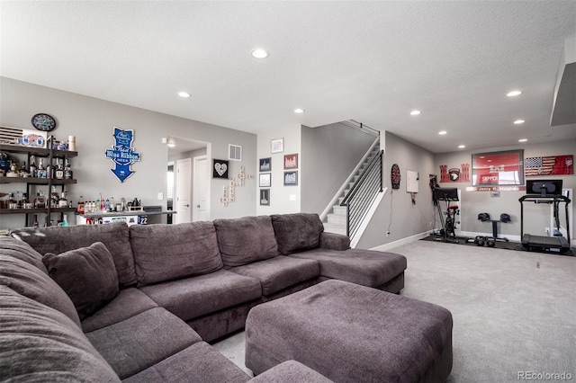 living room with light colored carpet and a textured ceiling