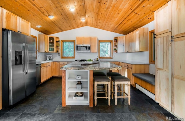 13416 Kuehster Rd, Littleton, CO 80127 - kitchen with stainless steel appliances, open shelves, lofted ceiling, a center island, and a kitchen breakfast bar