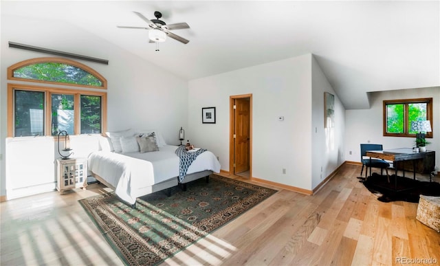 13416 Kuehster Rd, Littleton, CO 80127 - bedroom with vaulted ceiling, wood finished floors, an office area, and a ceiling fan