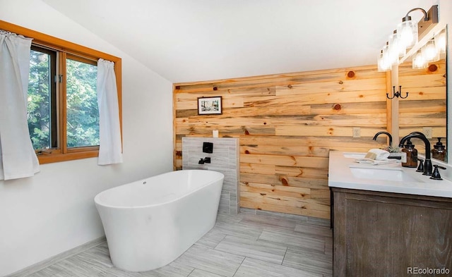 13416 Kuehster Rd, Littleton, CO 80127 - full bathroom with double vanity, a freestanding tub, wooden walls, and vaulted ceiling