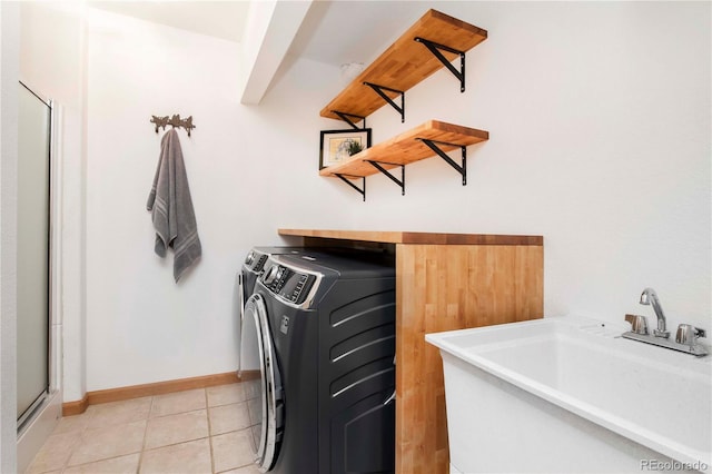 13416 Kuehster Rd, Littleton, CO 80127 - laundry room featuring separate washer and dryer and light tile patterned floors