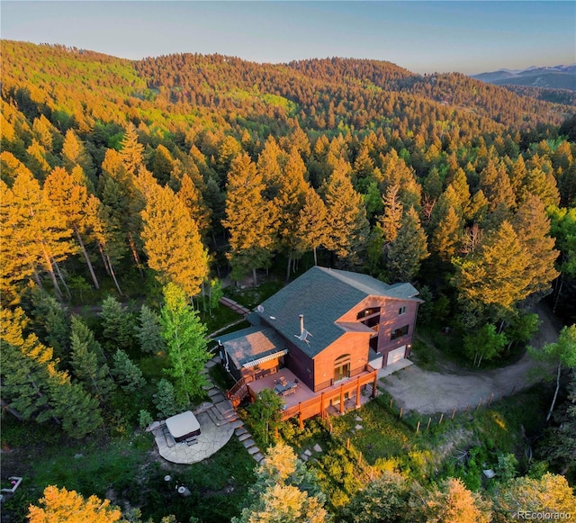 13416 Kuehster Rd, Littleton, CO 80127 - aerial view of property and surrounding area with a heavily wooded area and a mountainous background