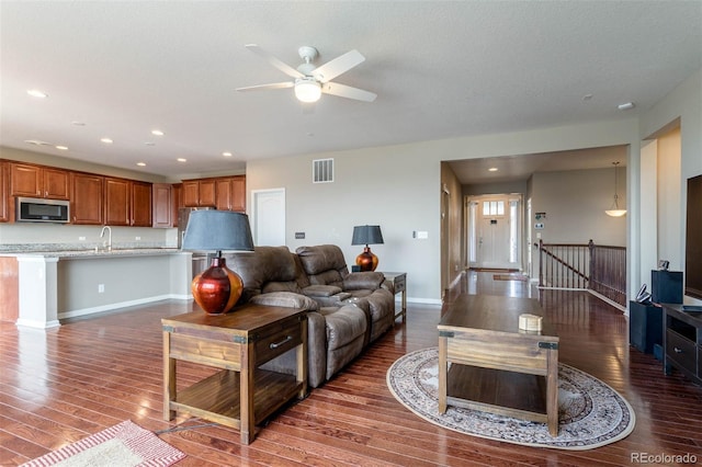6265 S Ider Way, Aurora, CO 80016 - living area with wood finished floors, recessed lighting, ceiling fan, and baseboards