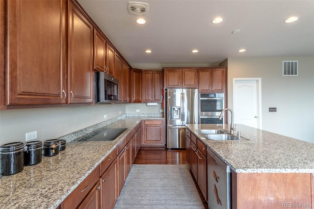 6265 S Ider Way, Aurora, CO 80016 - kitchen with a sink, stainless steel appliances, recessed lighting, an island with sink, and light stone counters