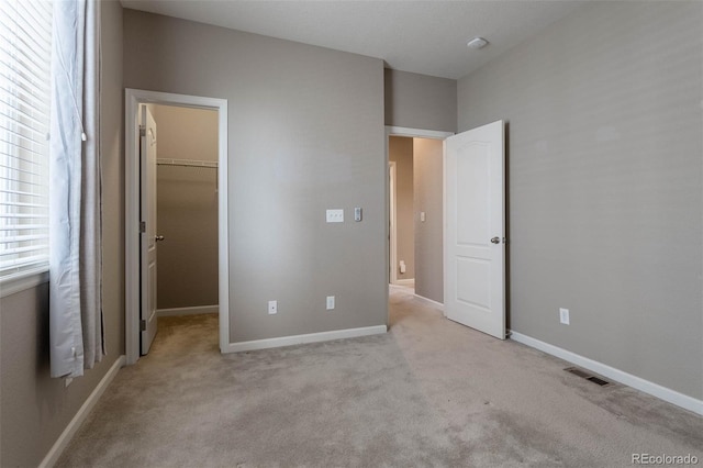 6265 S Ider Way, Aurora, CO 80016 - unfurnished bedroom with a spacious closet, carpet flooring, a closet, and baseboards