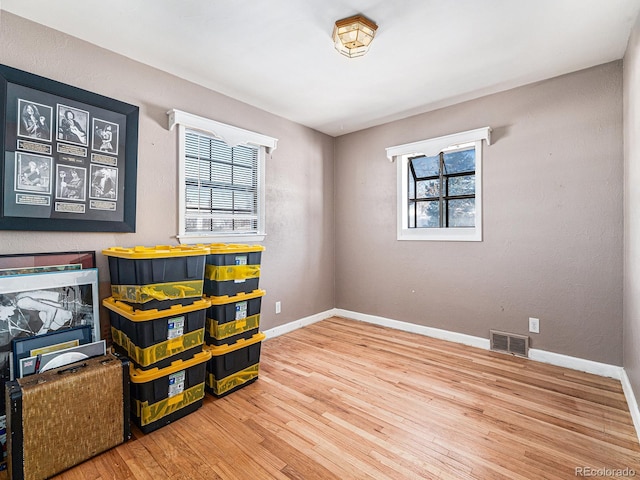 recreation room with plenty of natural light and wood-type flooring