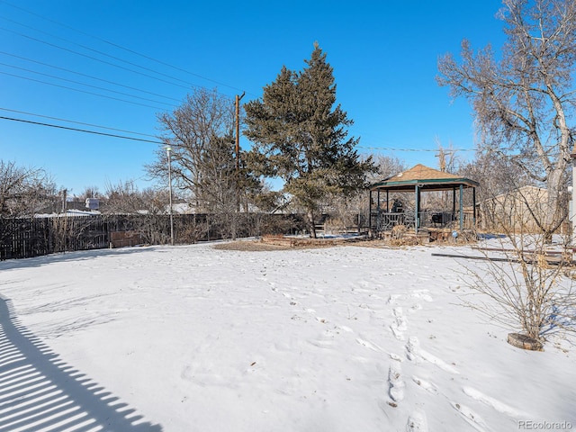 yard covered in snow with a gazebo