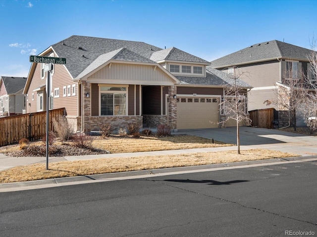 view of front of house featuring a shingled roof, brick siding, fence, and driveway