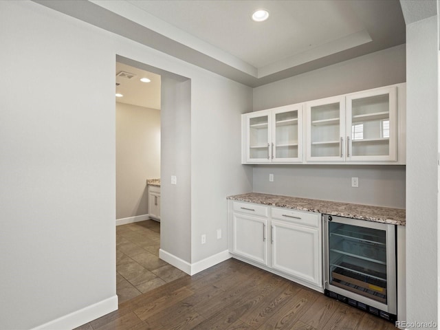 bar with wine cooler, dark wood-type flooring, recessed lighting, and baseboards