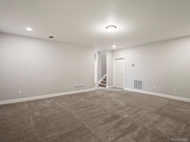 carpeted empty room with recessed lighting, visible vents, stairway, and baseboards