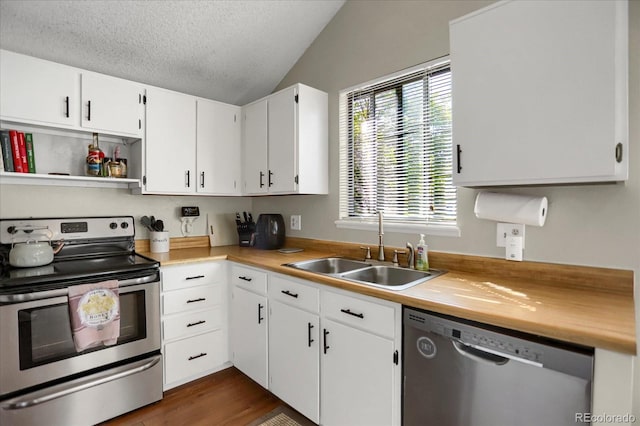 3853 S Genoa Ct Unit D, Aurora, CO 80013 - kitchen featuring stainless steel appliances, a sink, lofted ceiling, a textured ceiling, and white cabinetry