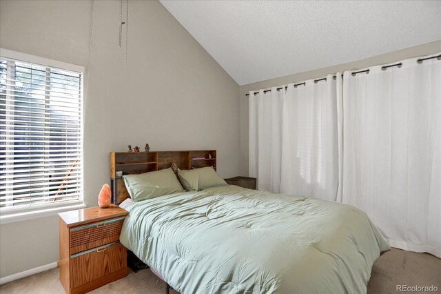 3853 S Genoa Ct Unit D, Aurora, CO 80013 - bedroom featuring light colored carpet, vaulted ceiling, and baseboards