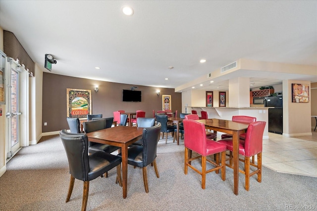 dining space with light tile patterned flooring