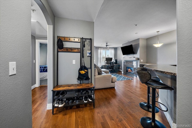 living room featuring hardwood / wood-style flooring and ceiling fan