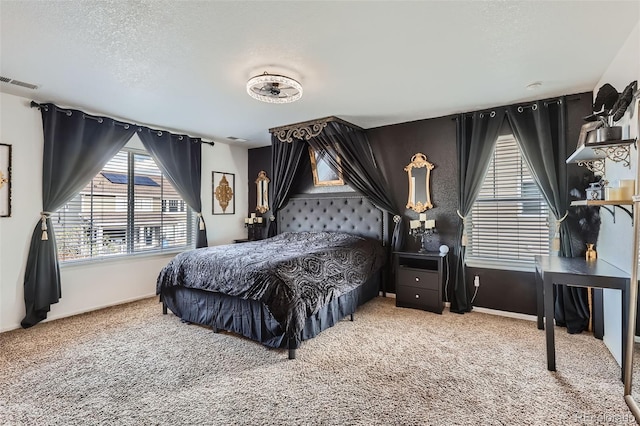 carpeted bedroom featuring a textured ceiling and baseboards