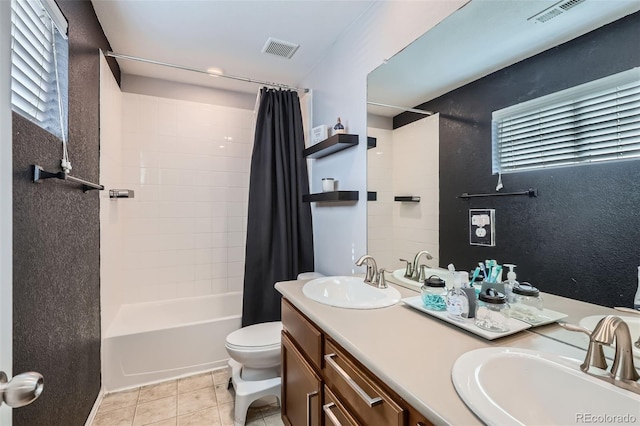 full bathroom featuring tile patterned floors, toilet, double vanity, and shower / tub combo