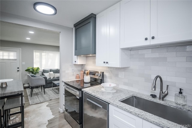 kitchen with white cabinetry, sink, and stainless steel appliances