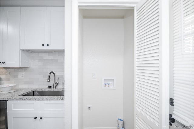 laundry room featuring washer hookup and sink