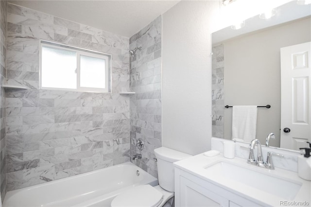 full bathroom featuring vanity, tiled shower / bath combo, and toilet