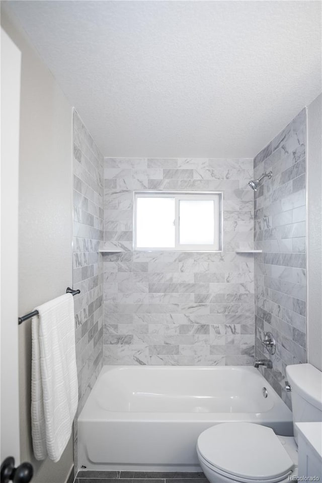 full bathroom featuring toilet, vanity, and tiled shower / bath