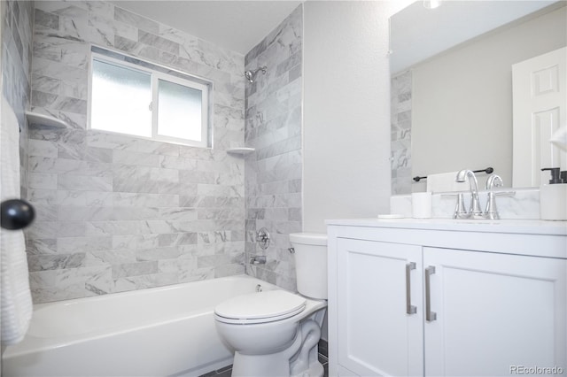 full bathroom featuring vanity, toilet, and tiled shower / bath