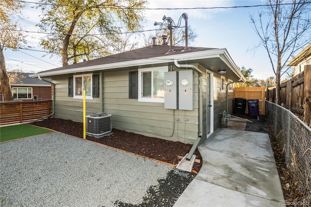 view of front of home with central AC and a patio