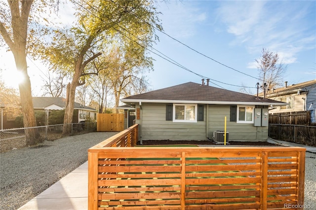 rear view of property with central AC