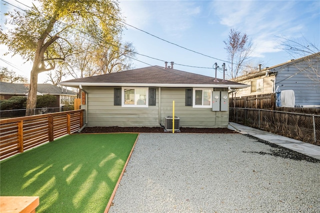 rear view of property featuring a yard