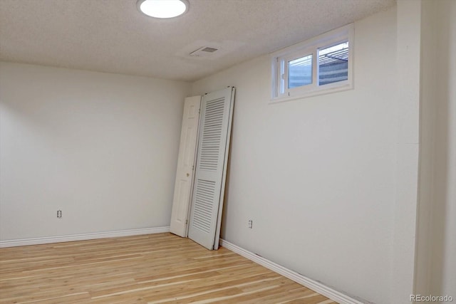 1641 Orchard Dr, Denver, CO 80221 - unfurnished bedroom featuring light wood-style flooring, baseboards, and a textured ceiling
