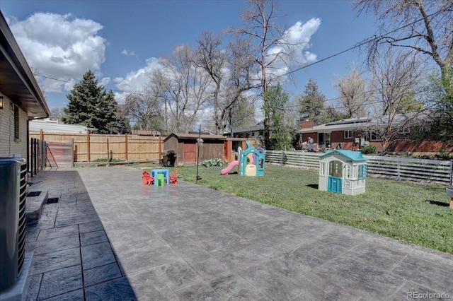 1641 Orchard Dr, Denver, CO 80221 - view of patio / terrace featuring a playground, a storage shed, an outdoor structure, and central AC unit