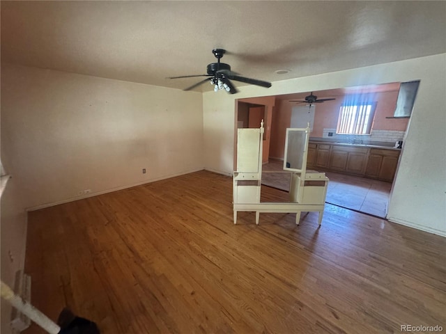 888 Wolff St, Denver, CO 80204 - unfurnished living room with light wood-type flooring and ceiling fan