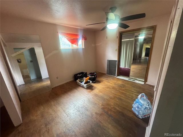 888 Wolff St, Denver, CO 80204 - empty room featuring wood finished floors, a ceiling fan, and a textured ceiling