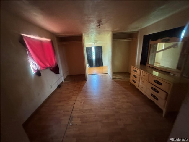 888 Wolff St, Denver, CO 80204 - unfurnished bedroom featuring two closets and wood finished floors