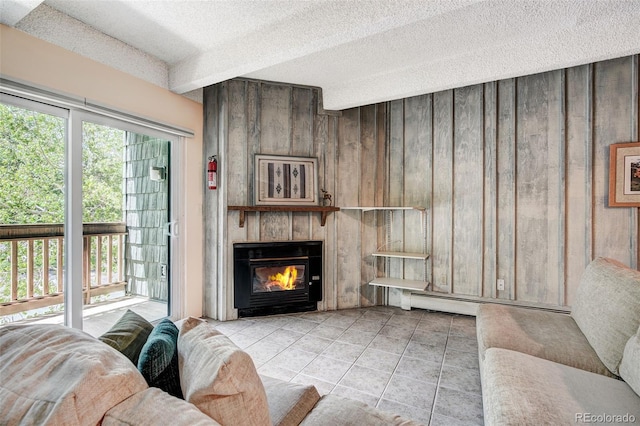 200 Granite St Unit 202, Frisco, CO 80443 - tiled living room with wood walls, a textured ceiling, a fireplace, and a baseboard heating unit