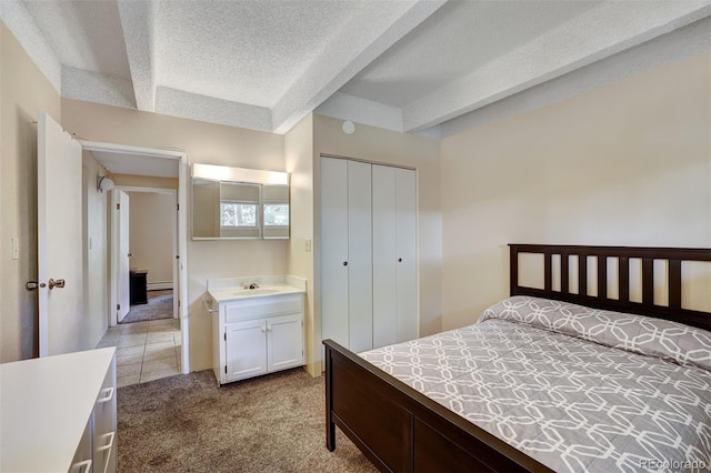 200 Granite St Unit 202, Frisco, CO 80443 - carpeted bedroom featuring a textured ceiling, a closet, and a baseboard heating unit