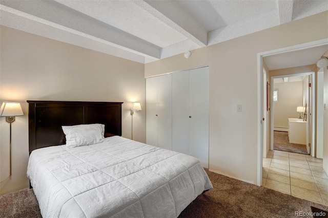 200 Granite St Unit 202, Frisco, CO 80443 - bedroom with light carpet, a closet, a baseboard radiator, and light tile patterned floors