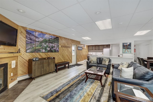 200 Granite St Unit 202, Frisco, CO 80443 - living room with wooden walls, a baseboard radiator, a paneled ceiling, and wood finished floors