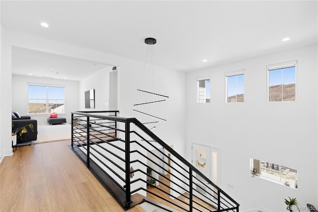 hallway featuring recessed lighting, an upstairs landing, and light wood-style flooring