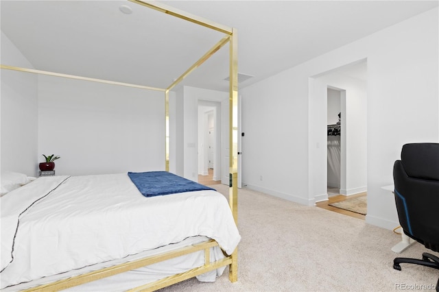 carpeted bedroom with visible vents and baseboards