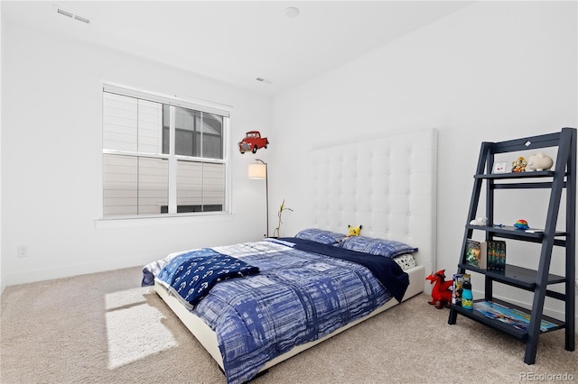 bedroom with visible vents and carpet flooring