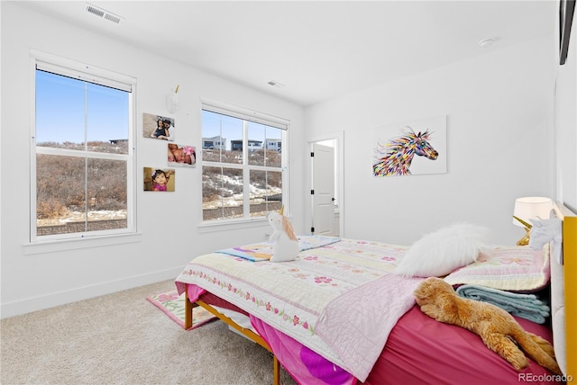 carpeted bedroom featuring visible vents and baseboards