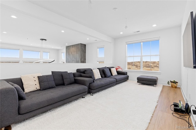 living room with recessed lighting, wood finished floors, visible vents, and baseboards