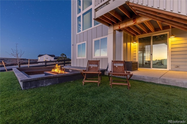 exterior space with a patio, a yard, a fire pit, and board and batten siding